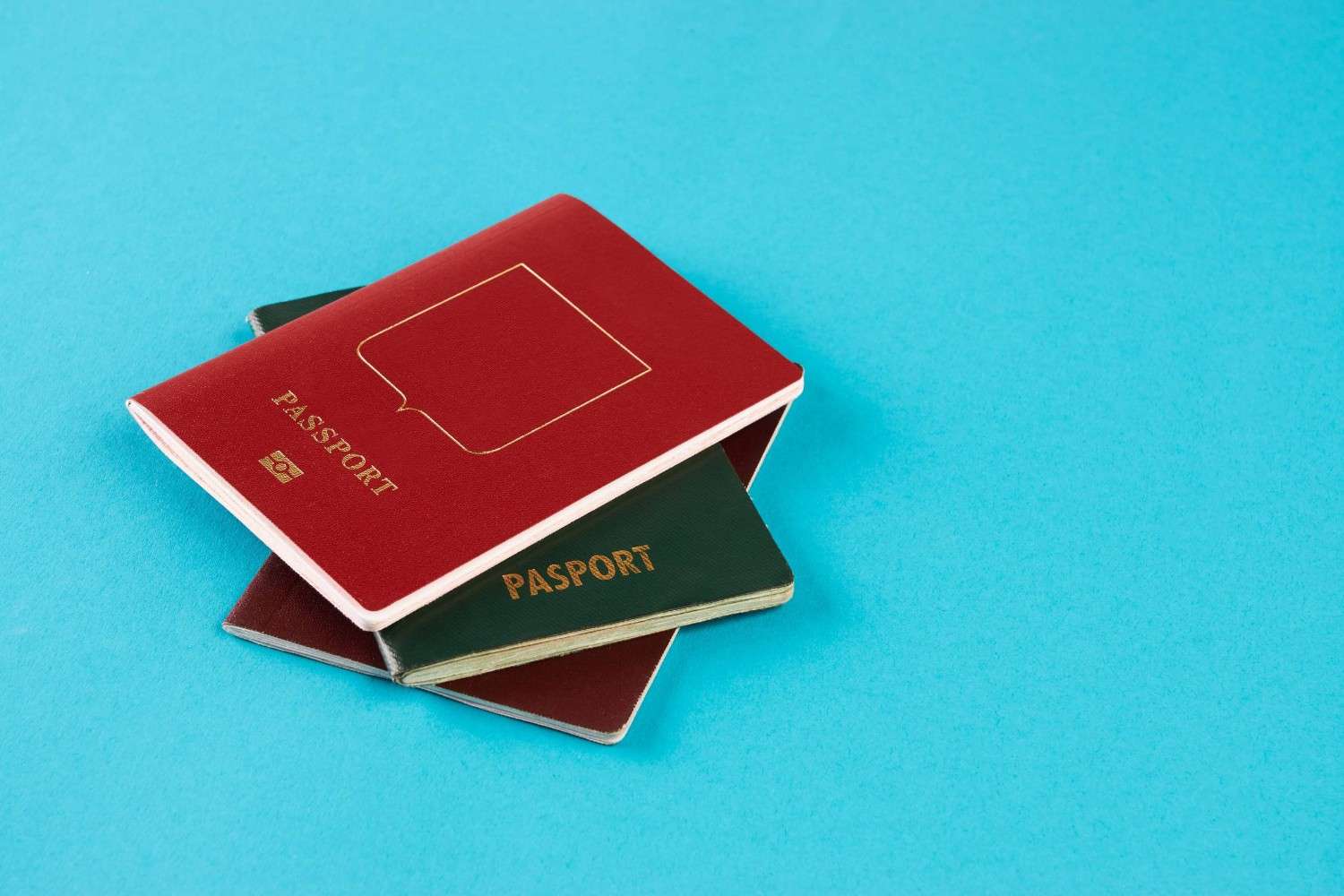 3 Passports Stacked On Top Of Each Other