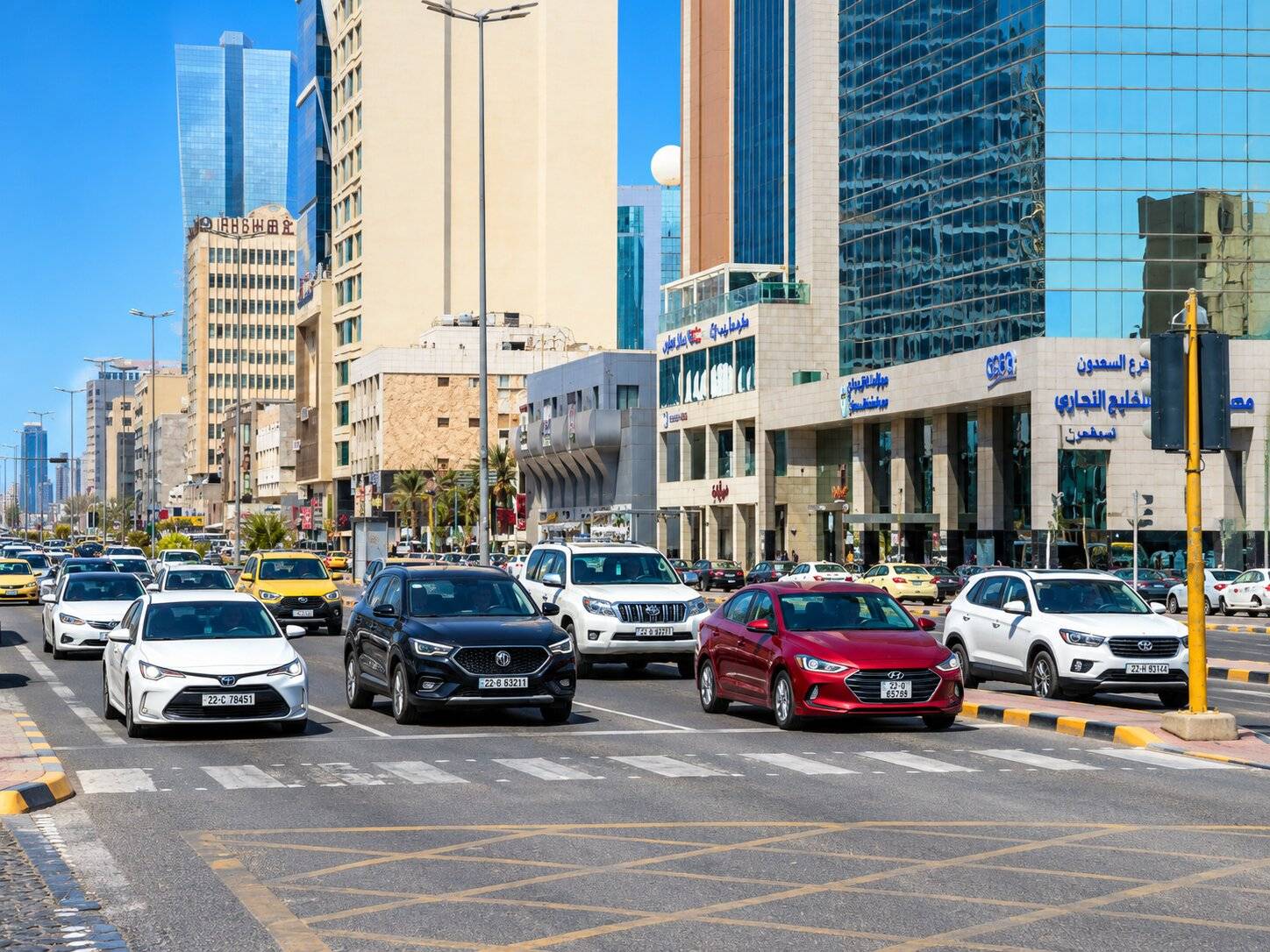 Cars Waiting At A Red Light On A Busy City Street